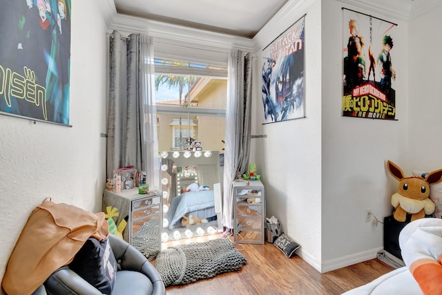 interior space featuring wood-type flooring and ornamental molding