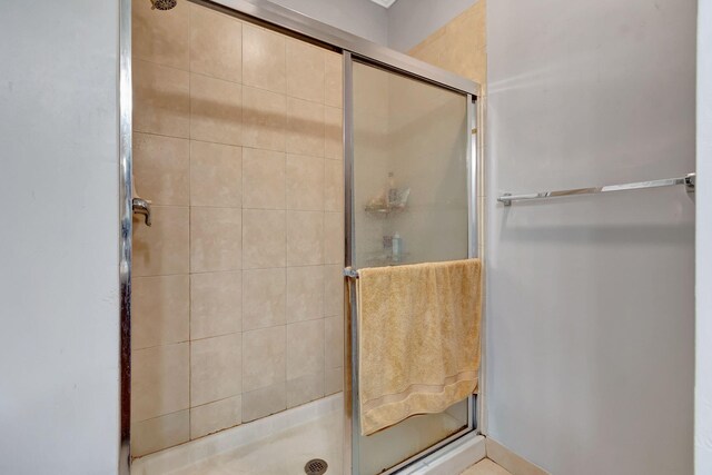 bathroom featuring walk in shower, tile patterned floors, vanity, and ornamental molding