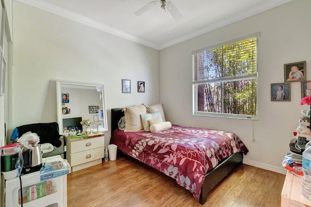 bedroom featuring light wood-type flooring, ceiling fan, and crown molding