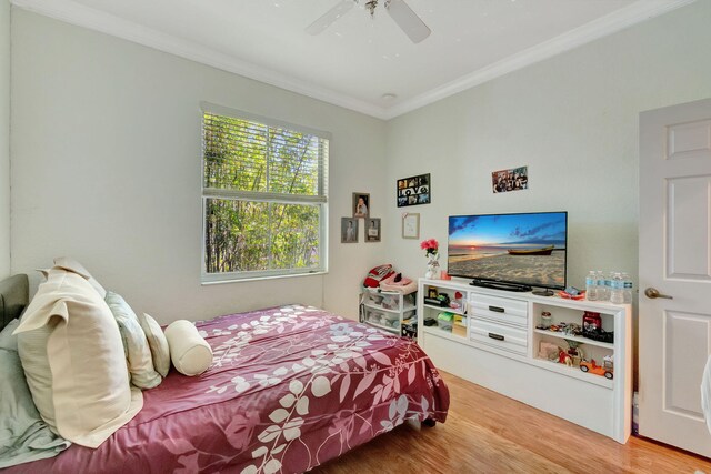 bedroom featuring wood-type flooring, ceiling fan, and crown molding