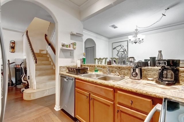 kitchen with dishwasher, sink, an inviting chandelier, light hardwood / wood-style flooring, and ornamental molding