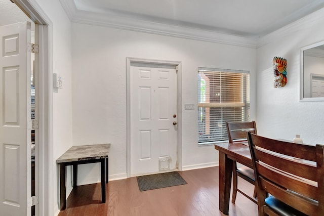 foyer entrance with crown molding and dark hardwood / wood-style flooring