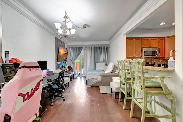 bedroom featuring hardwood / wood-style floors, a chandelier, and ornamental molding