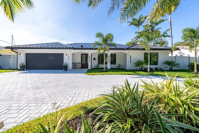 view of front of home with a garage and a front lawn