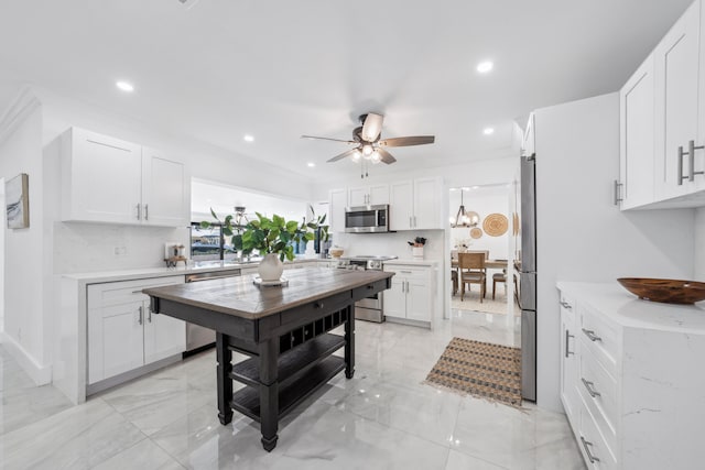 dining space featuring ceiling fan and crown molding