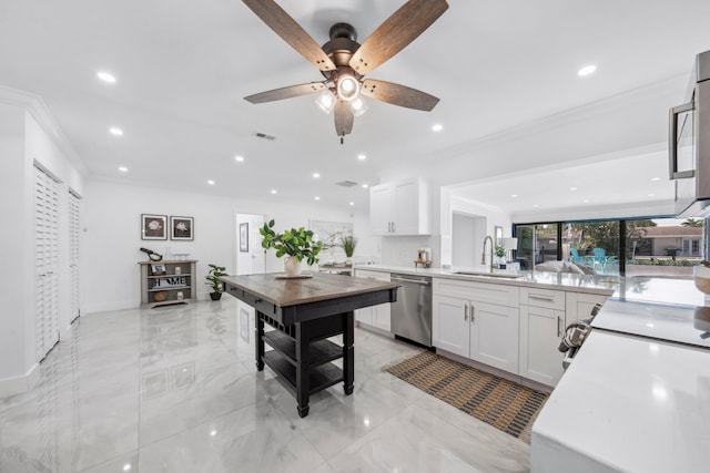 kitchen with white cabinetry, dishwasher, ceiling fan, and sink