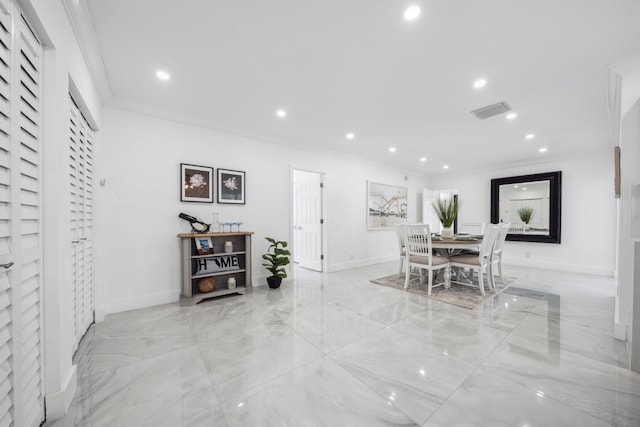 dining space with crown molding