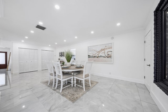 dining room featuring crown molding