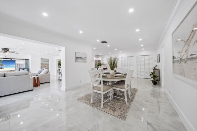 dining space with ceiling fan and crown molding