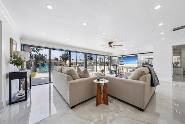 living room featuring ceiling fan and ornamental molding