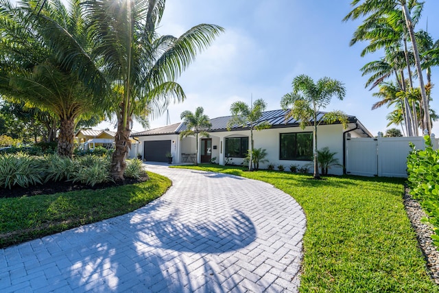 view of front of house with a front yard and a garage