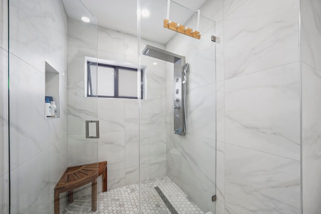 bathroom featuring a shower with shower door