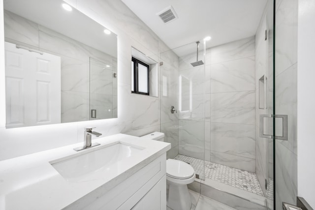 bathroom with toilet, an enclosed shower, tile walls, and vanity