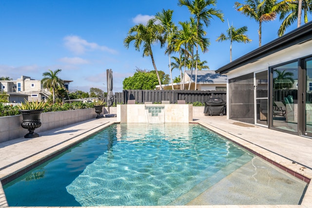 view of pool featuring a patio area and a grill