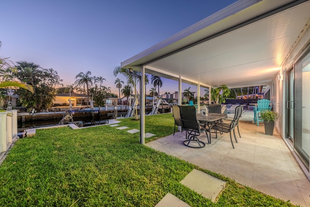 yard at dusk with a patio area