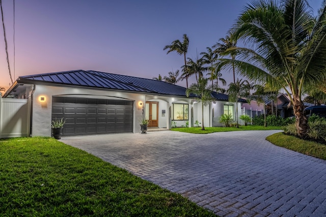 view of front of house with a yard and a garage