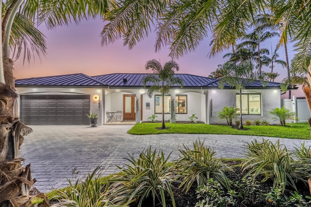 view of front of house with a yard and a garage