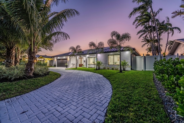 view of front of home with a lawn and a garage