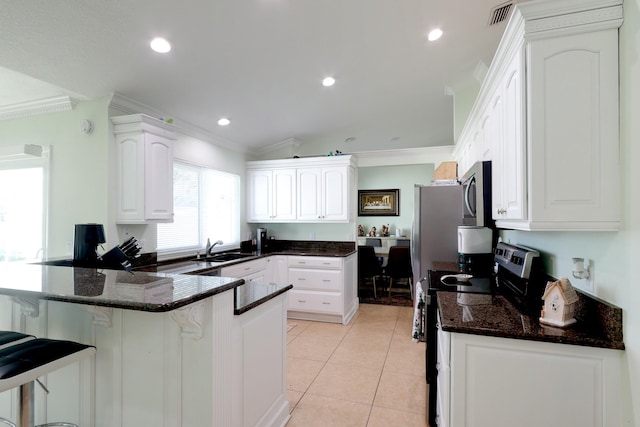 kitchen with kitchen peninsula, white cabinets, sink, and black electric range oven