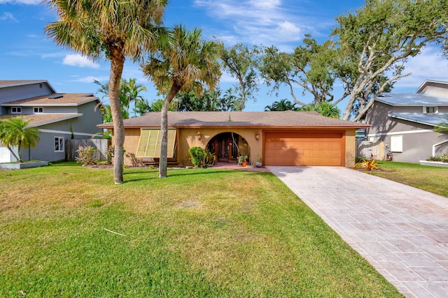 ranch-style home featuring a garage and a front yard