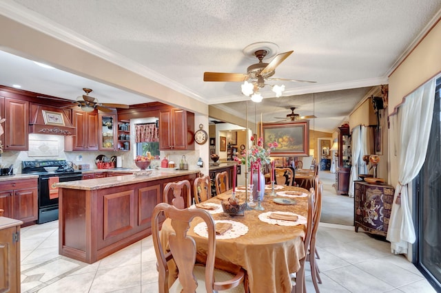 tiled dining space featuring a textured ceiling and ornamental molding