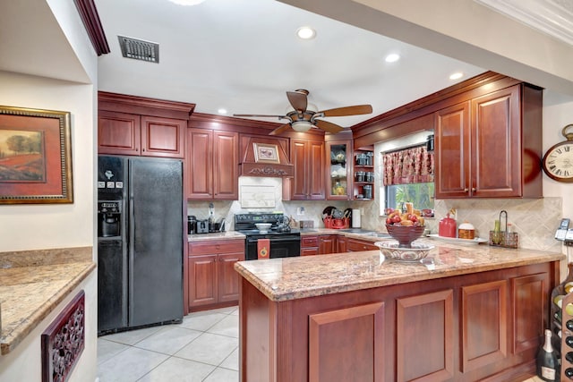 kitchen with backsplash, premium range hood, black appliances, light tile patterned floors, and light stone countertops