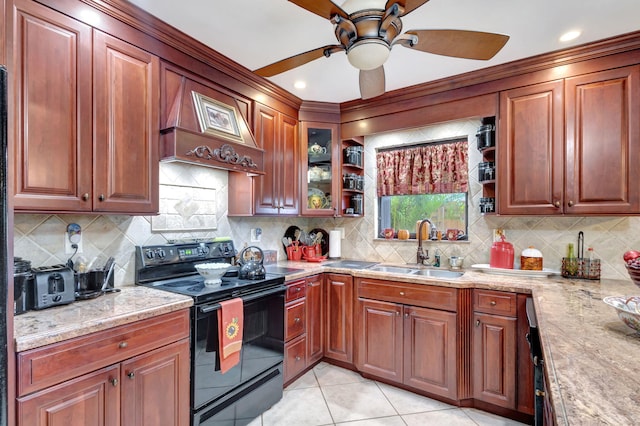 kitchen featuring black electric range oven, sink, decorative backsplash, light stone countertops, and custom range hood