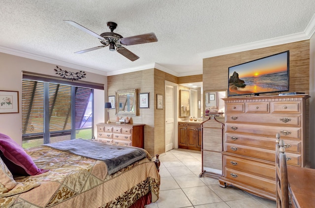 tiled bedroom with a textured ceiling, ceiling fan, crown molding, and connected bathroom