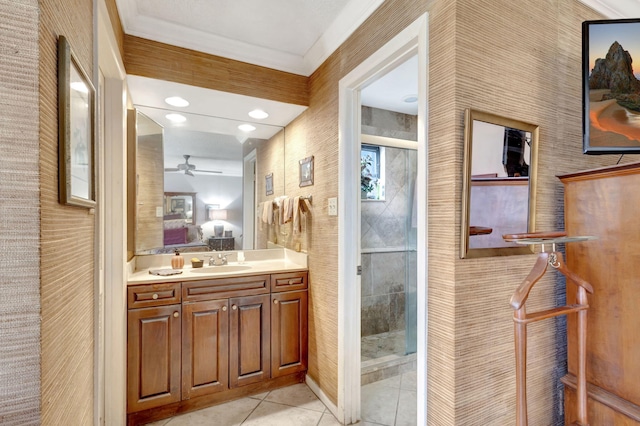 bathroom featuring tile patterned flooring, vanity, ceiling fan, and ornamental molding