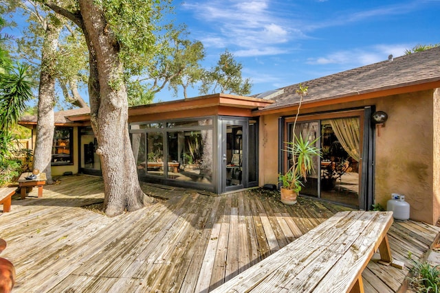 wooden deck with a sunroom