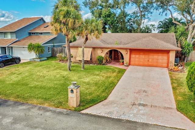 view of front of property with a garage and a front yard