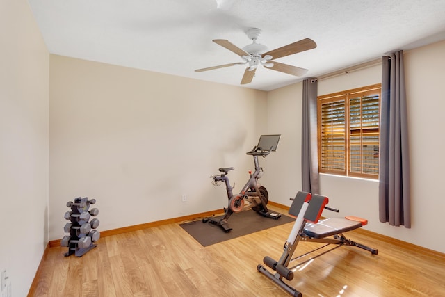 workout room with a textured ceiling, hardwood / wood-style flooring, and ceiling fan