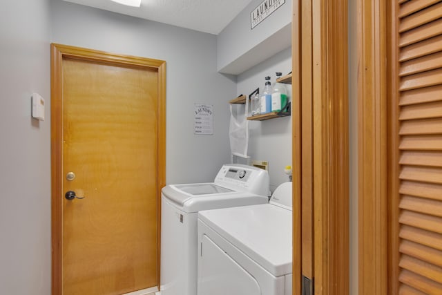 washroom with independent washer and dryer and a textured ceiling