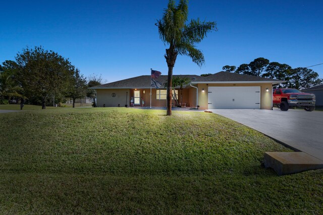 ranch-style home with a front yard and a garage