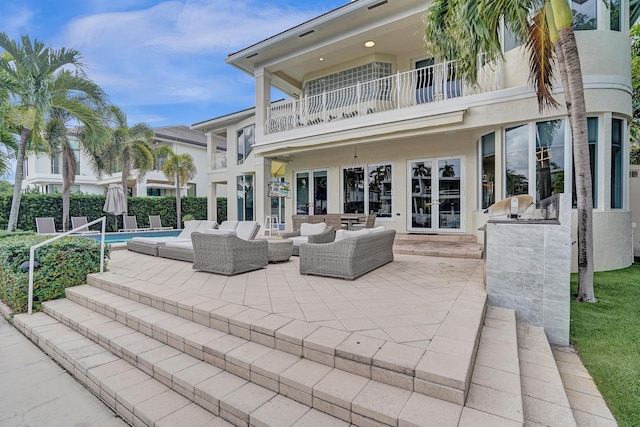 view of patio with a balcony, an outdoor kitchen, and an outdoor hangout area