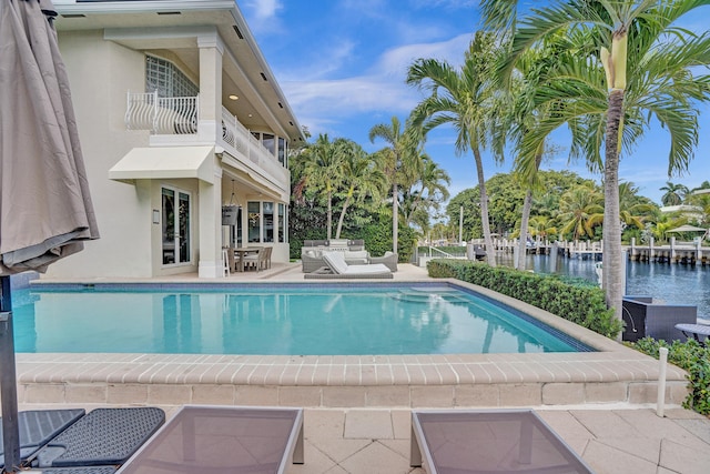 view of pool featuring a patio and a water view