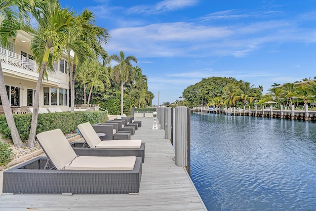 view of dock featuring a water view and a balcony