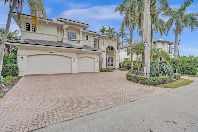 mediterranean / spanish-style house with a garage