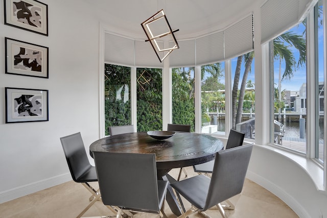 sunroom / solarium featuring a water view