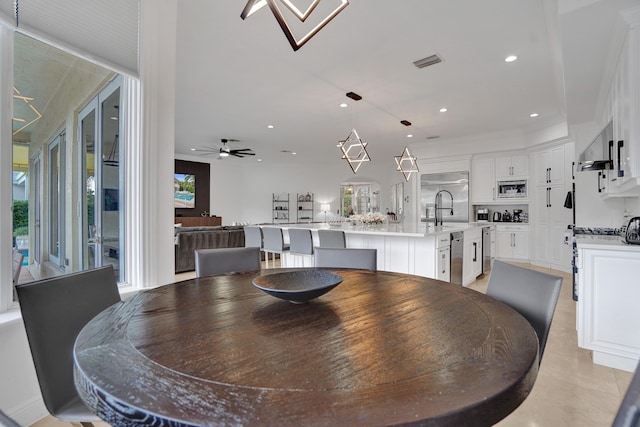 dining space featuring sink, a wealth of natural light, and ceiling fan