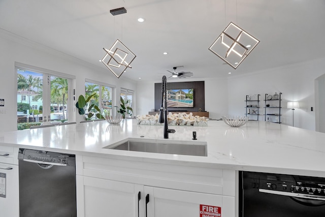 kitchen featuring dishwasher, white cabinets, hanging light fixtures, and sink