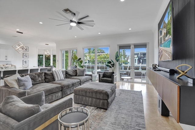 living room featuring ceiling fan and ornamental molding