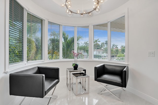 living area featuring an inviting chandelier and a healthy amount of sunlight