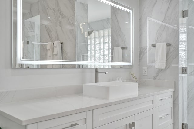 bathroom with vanity and a shower with shower door