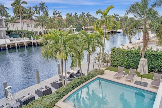 view of pool with a patio area and a water view