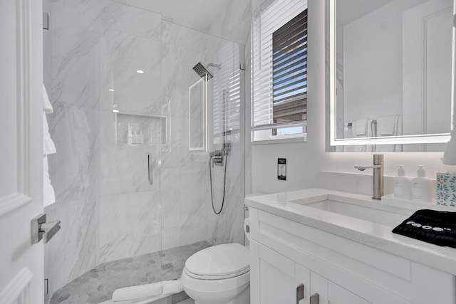 bathroom featuring vanity, toilet, and walk in shower