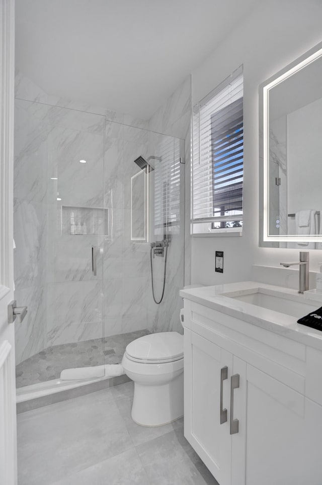 bathroom featuring walk in shower, vanity, and toilet