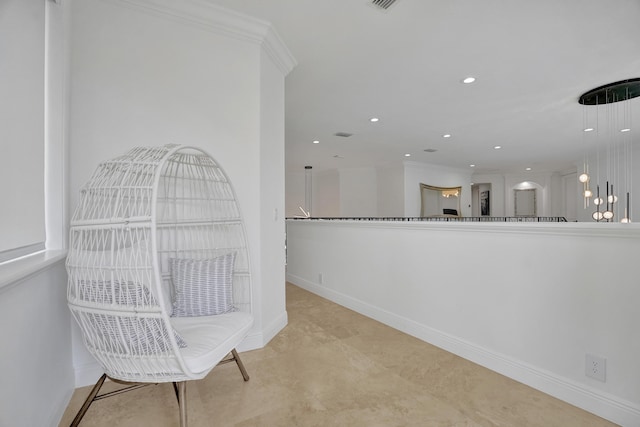 sitting room featuring crown molding