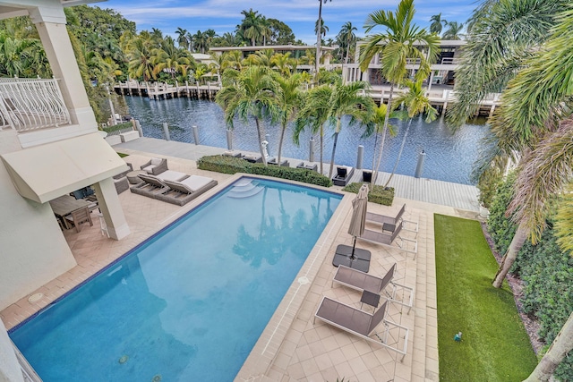 view of pool featuring a patio area, a dock, and a water view