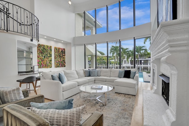 living room featuring a premium fireplace and a towering ceiling